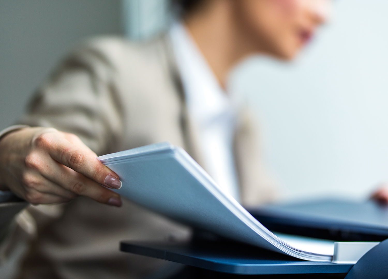 Close up of a secretary working on cloud fax machine.