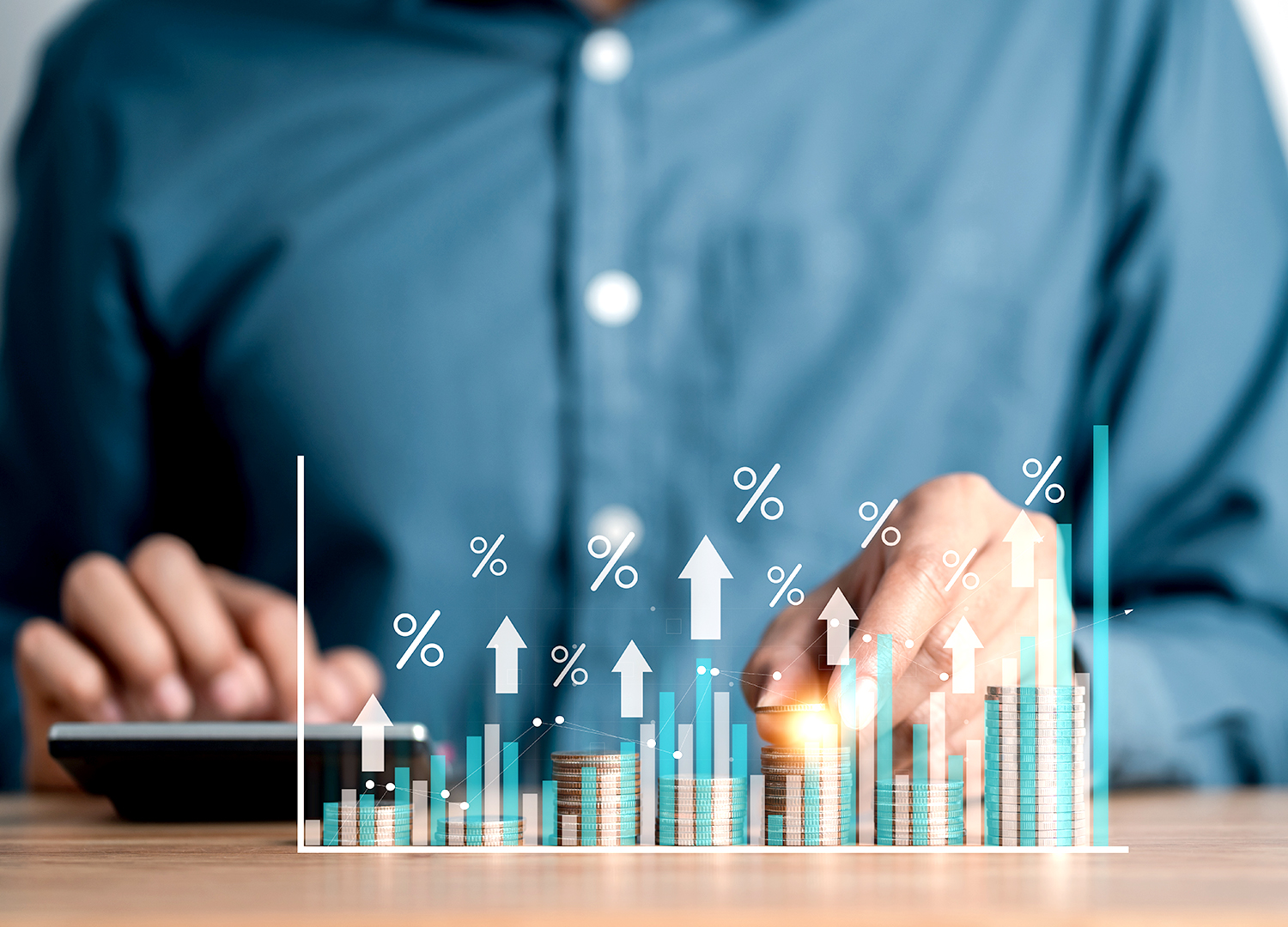 Businessman looking at revenue charts trending upwards. 